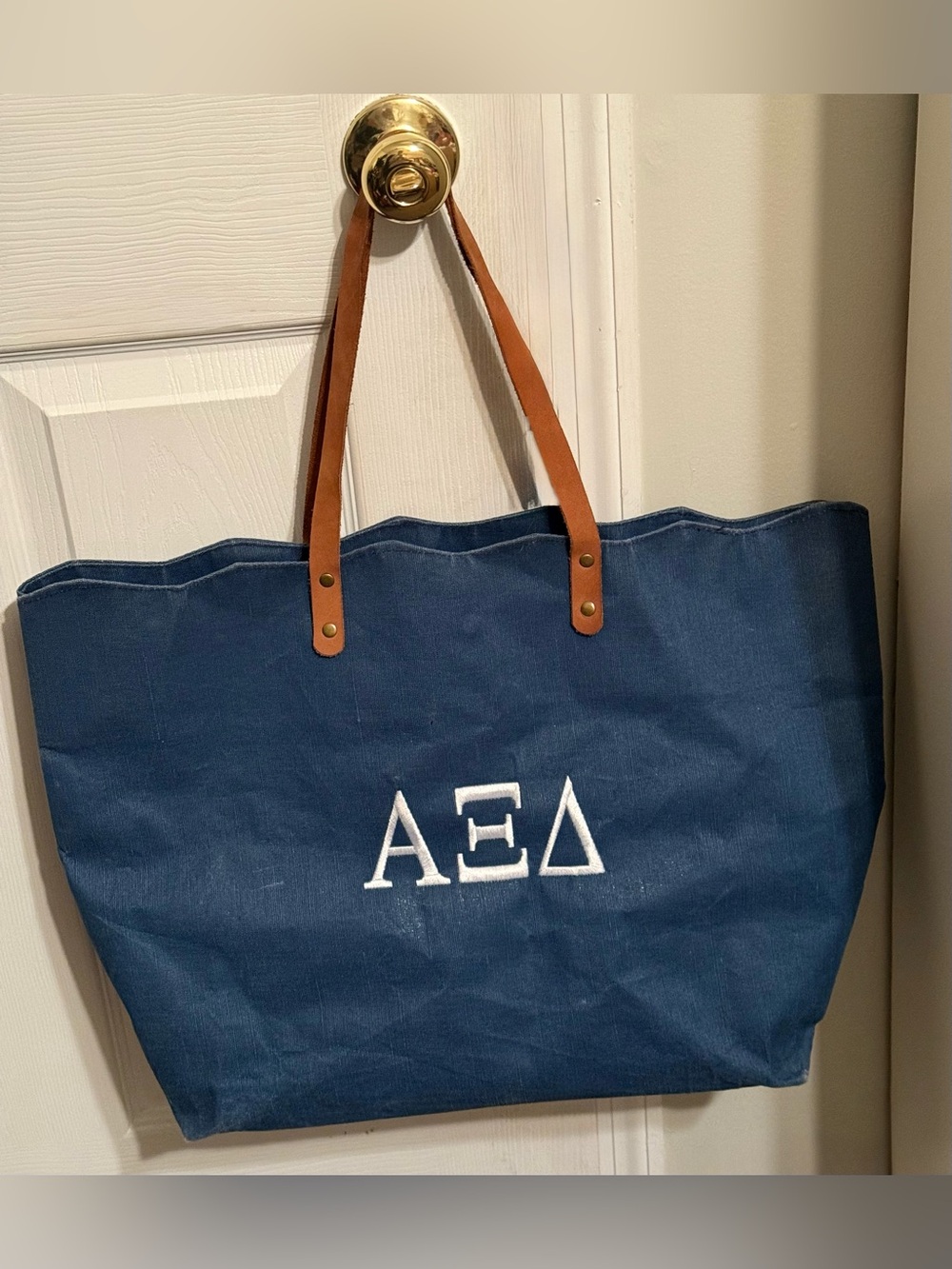 The Royal Standard Alpha Xi Delta Blue Canvas Embroidered Tote Bag leather strap